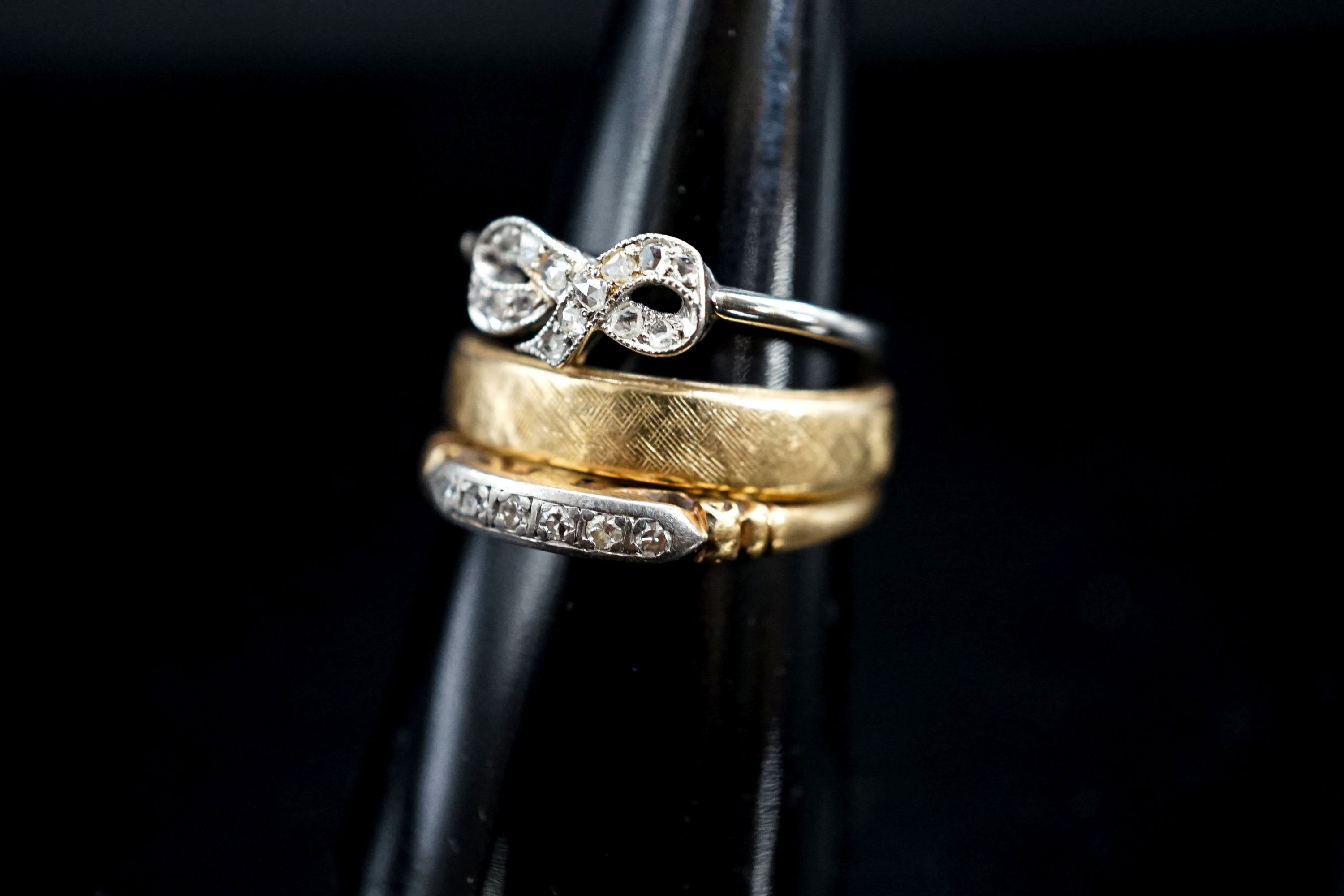 A 14k yellow metal band and two other diamond set rings, one stamped 14k, gross weight 7.5 grams.